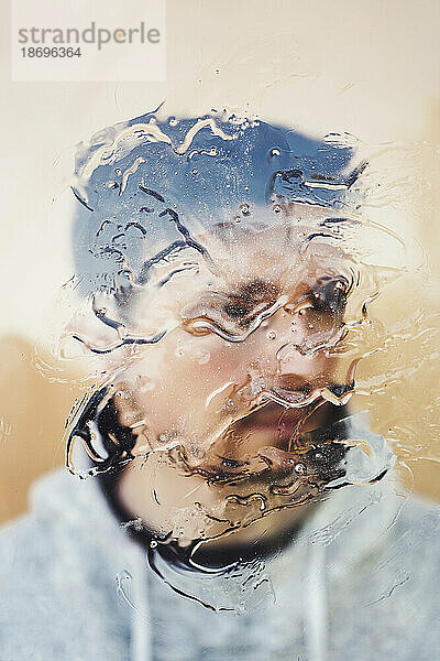 Man behind glass with water