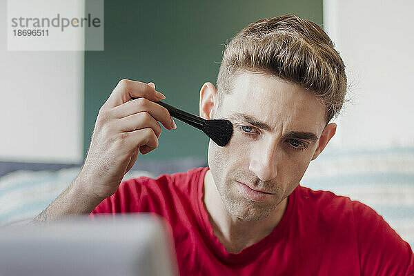 Man applying make-up with brush