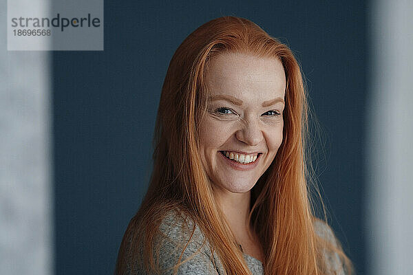 Portrait of cheerful redhead woman