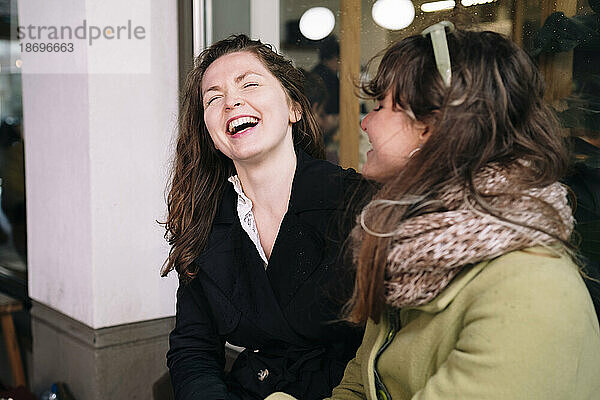 Happy female friends laughing together