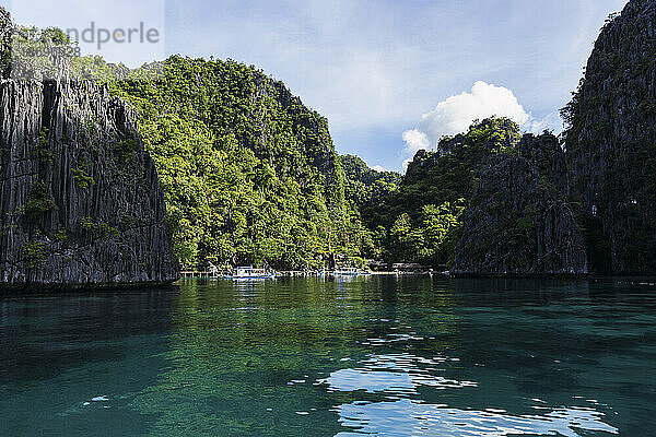 Reflection of mountains in sea at Coron Island in Philippines
