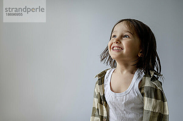 Excited boy against white background