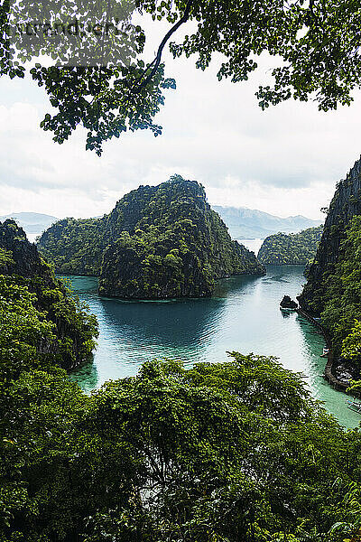 Green mountains amidst sea at Coron Island in Philippines