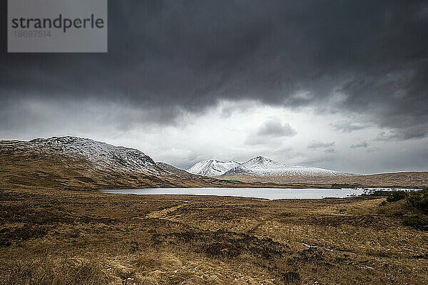 UK  Scotland  Storm clouds gathering over lake in Rannoch Moor
