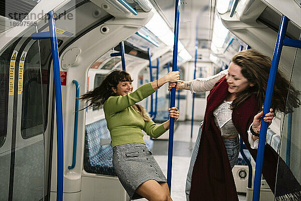 Female friends having fun in subway