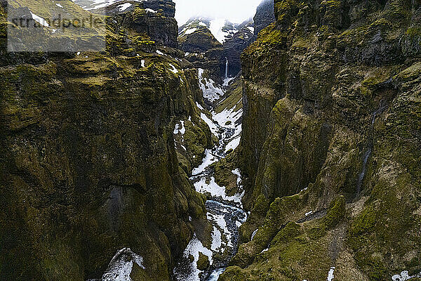 Ein Paradies für Wanderer  der Mulagljufur Canyon mit atemberaubender Aussicht auf einen gewundenen Gebirgsfluss und einen abgelegenen Wasserfall an den felsigen Klippen; Vik  Südisland  Island
