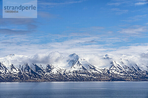 Nahaufnahme der wunderschönen schneebedeckten Berge der Nordfjorde in Nordisland mit einem strahlend blauen Himmel darüber; Nordisland  Island