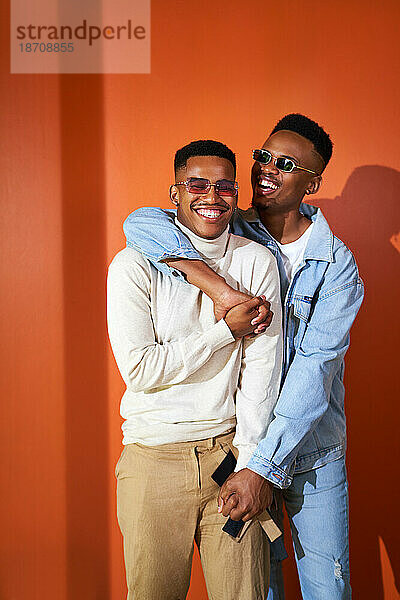 Porträt eines glücklichen jungen schwulen männlichen Paares  das lacht und sich umarmt