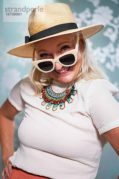 Portrait happy  playful senior woman in sunglasses and hat