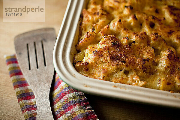 Eine Pfanne mit Makkaroni und Käse  gebacken mit Bio-Eichelkürbis  steht neben einem Pfannenwender in einer Küche in Seattle  Washington.