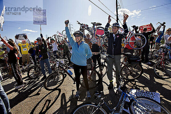 Radfahrer klatschen und singen vor einem Kohlekraftwerk während einer Kundgebung gegen die Kohlekraft und zur Sensibilisierung für die globale Erwärmung am internationalen Aktionstag von 350.or