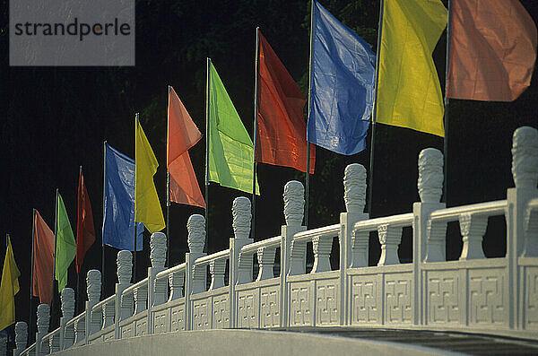 Fußgängerbrücke mit bunten Flaggen in Singapur.