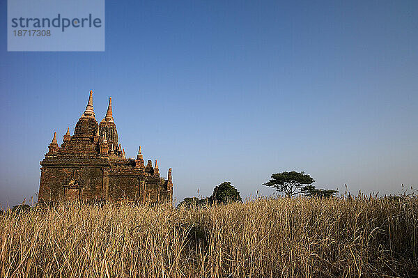 A group of 13th-century pagodas of varying sizes stand among farm fields lining the shores of the Irrawaddy river at Bagan  Union of Myanmar (Burma)