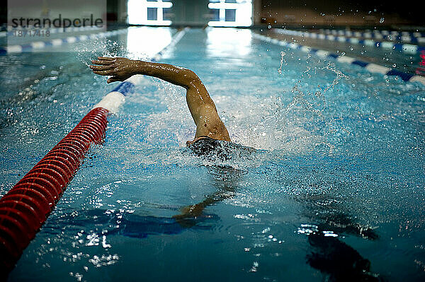 Ein Athlet  der nur ein Bein hat  schwimmt während des Trainings Runden.