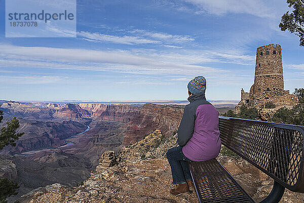 USA  Arizona  Rückansicht einer Touristin  die auf einer Bank im Grand Canyon National Park sitzt