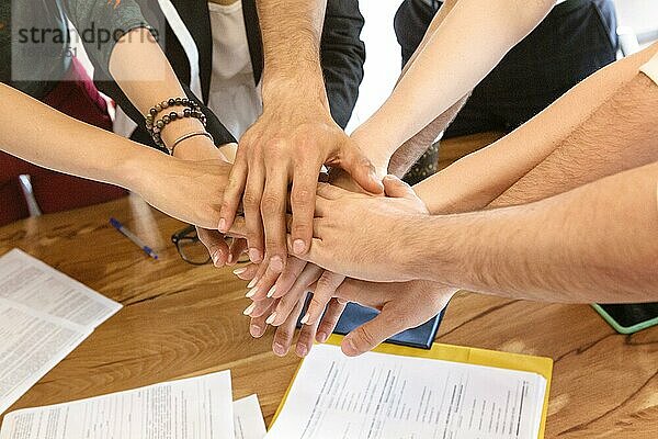 Geschäftsleute falten ihre Hände zusammen. Team und Erfolgskonzept