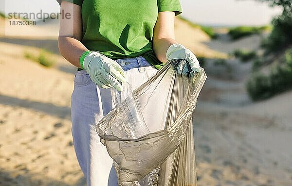 Freiwillige sammeln Müll  Plastikmüll Flaschen und Maske am Strand. Ökologie  Umwelt  Verschmutzung und ökologische Probleme Konzept