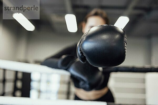 Starke lateinischen Boxen Frau auf den Ring im Fitnessstudio. Athletische Mädchen Ausbildung Muay Thai Boxen für Bodybuilding und gesunden Lebensstil Konzept. Workout im Sportverein