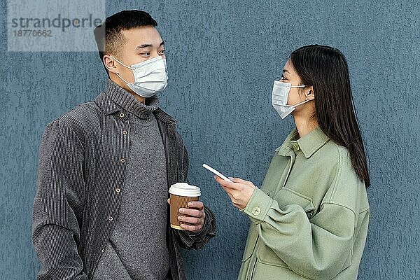 Junges japanisches Paar mit Maske