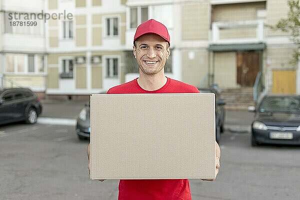 Lächelnder Mann liefert Paket aus