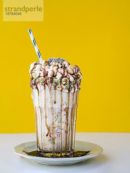 Vorderansicht leckerer Milchshake mit gelbem Hintergrund. Foto mit hoher Auflösung