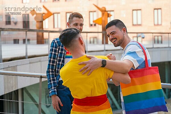 Freunde winken und umarmen bei der Demonstration mit den Regenbogenfahnen  Gay Pride Party in der Stadt  lgbt Konzept