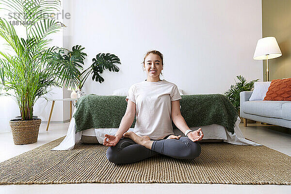 Woman with diabetes practicing lotus position at home