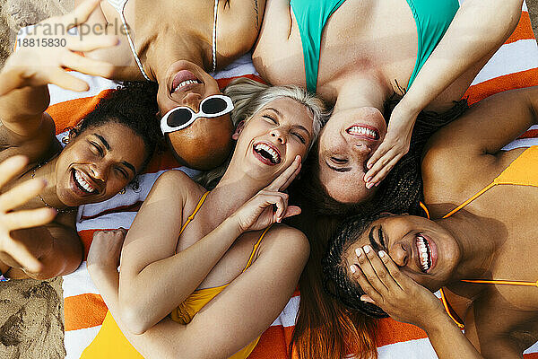 Carefree multiracial friends enjoying together at beach