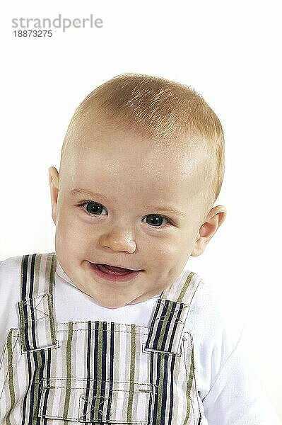 Portait von Baby Boy lächelnd gegen weißen Hintergrund