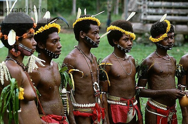 Frau und Männer in traditioneller Kleidung  Trobriand-Inseln  Papua-Neuguinea  Ozeanien