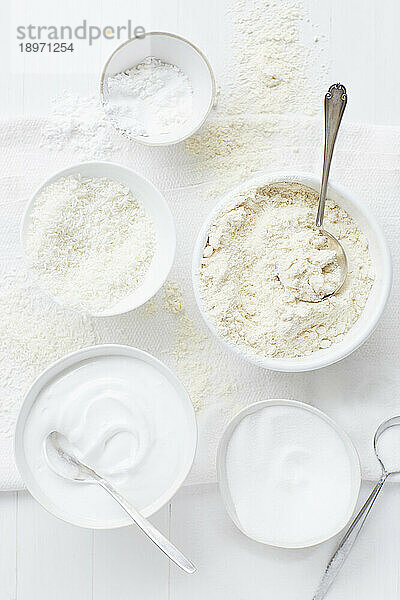 White bowls with white baking ingredients