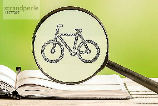 Fahrradsuche mit einer Bleistiftzeichnung eines Fahrrads in einem Vergrößerungsglas