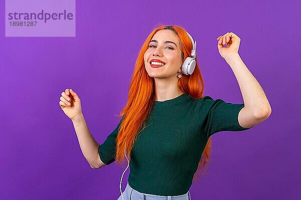 Rothaarige Frau im Studio Fotografie tanzen auf einem lila Hintergrund