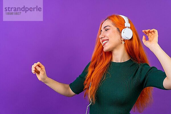 Rothaarige Frau im Studio Fotografie tanzen auf einem lila Hintergrund