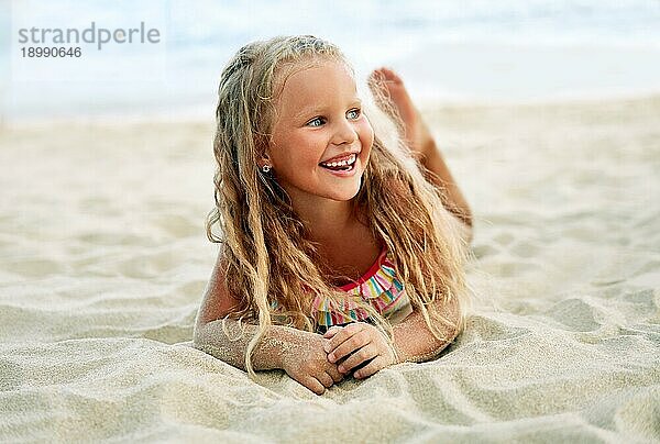 Adorable kleine blonde Mädchen entspannen am Sandstrand genießen Meer. Lächelnd hübsches Kind posiert am Strand. Sommerurlaub  glückliche Kindheit und Emotionen Konzept
