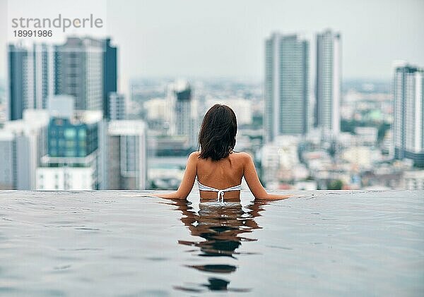 Rückenansicht von schlanken schönen Frau entspannen im Schwimmbad. Sommerurlaub Konzept