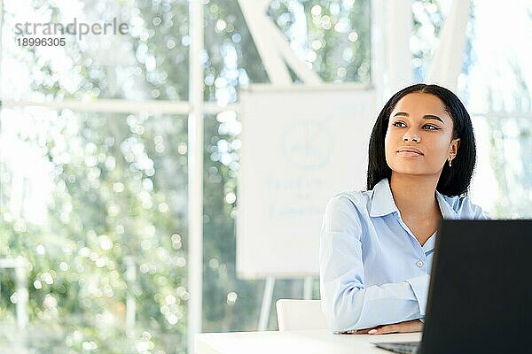 selbstbewusste  hübsche  schwarze Geschäftsfrau in einem hellen  modernen Büro  die den Raum kopieren möchte. Geschäftserfolgskonzept