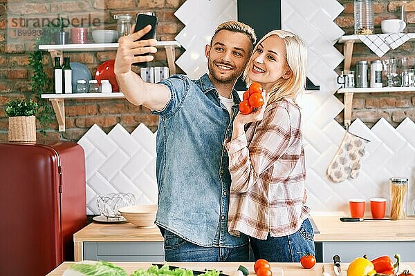 Junges glückliches Paar macht Selfie in ihrer Küche zu Hause