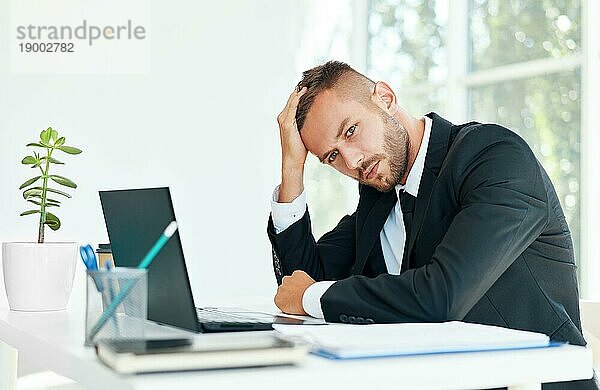Gestresste müde Geschäftsmann sitzt am Schreibtisch in kreativen Büro. Mann leiden unter Kopfschmerzen  Probleme Konzept