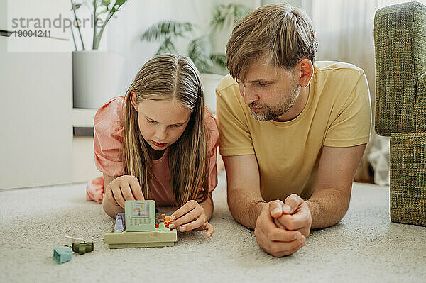 Father and daughter playing game at home