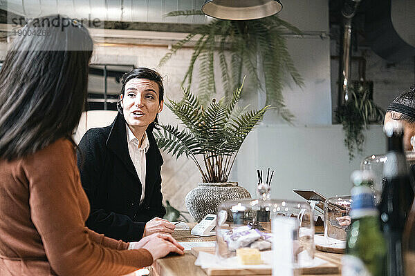 Businesswoman talking with office colleague at cafe