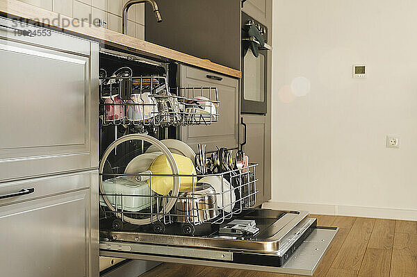 Clean dishes inside dishwasher in beautiful kitchen