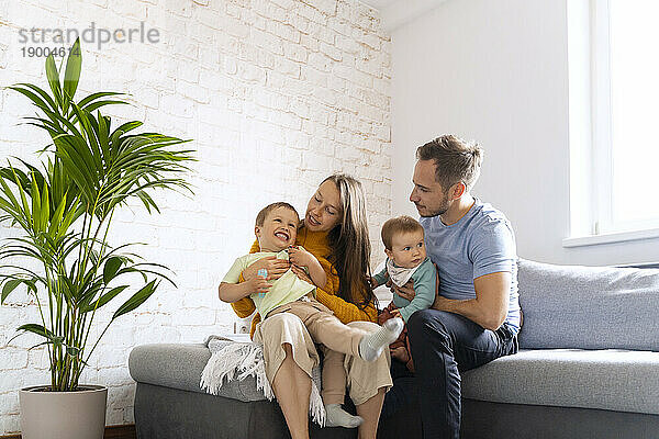 Happy family spending leisure time sitting in living room