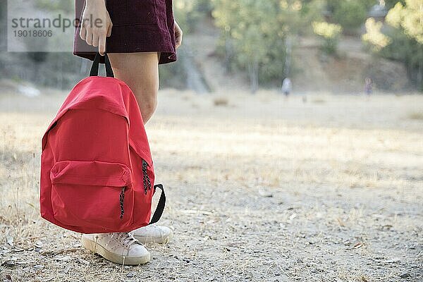 Teenager wartet mit Rucksack Hand Park. Schönes Foto