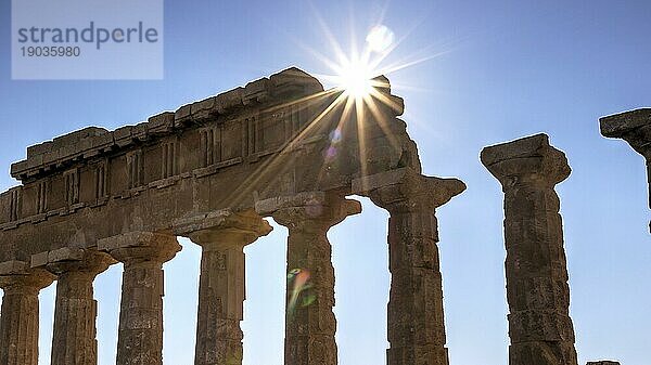 Säulenreihe  Kapitel  Gebälk  Gegenlichtaufnahme  Sonne als Stern  Sonne über Gebälk  Tempel C  Apollon Tempel  Selinunte  Archäologische Stätte  Tempel  Südwestsizilien  Sizilien  Italien  Europa