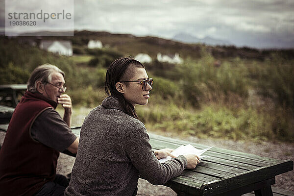 Zwei Personen blicken auf die Berge in Schottland