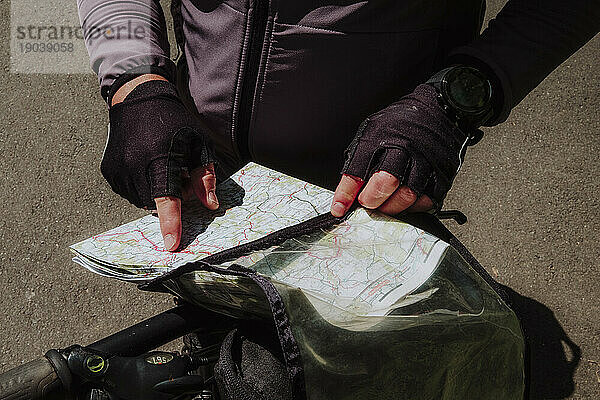 A cyclist looking the map