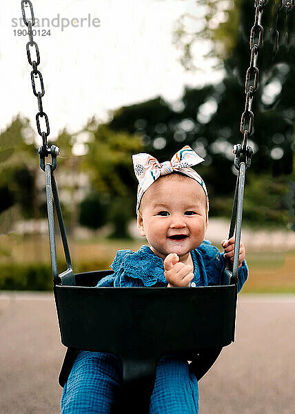 Baby Girl Swinging At Park