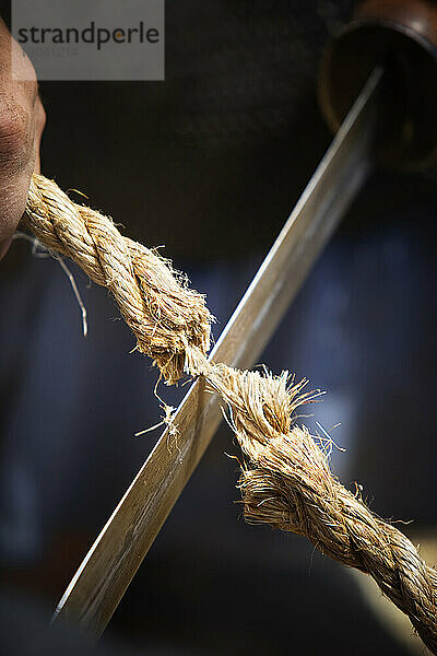 Blade cutting rope.