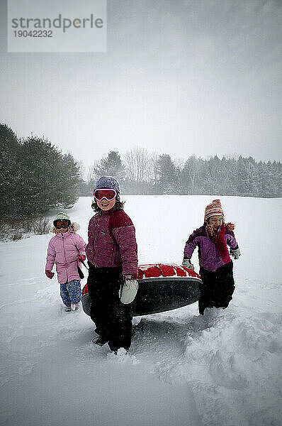 Kinder spielen draußen an einem Wintertag  Maine.